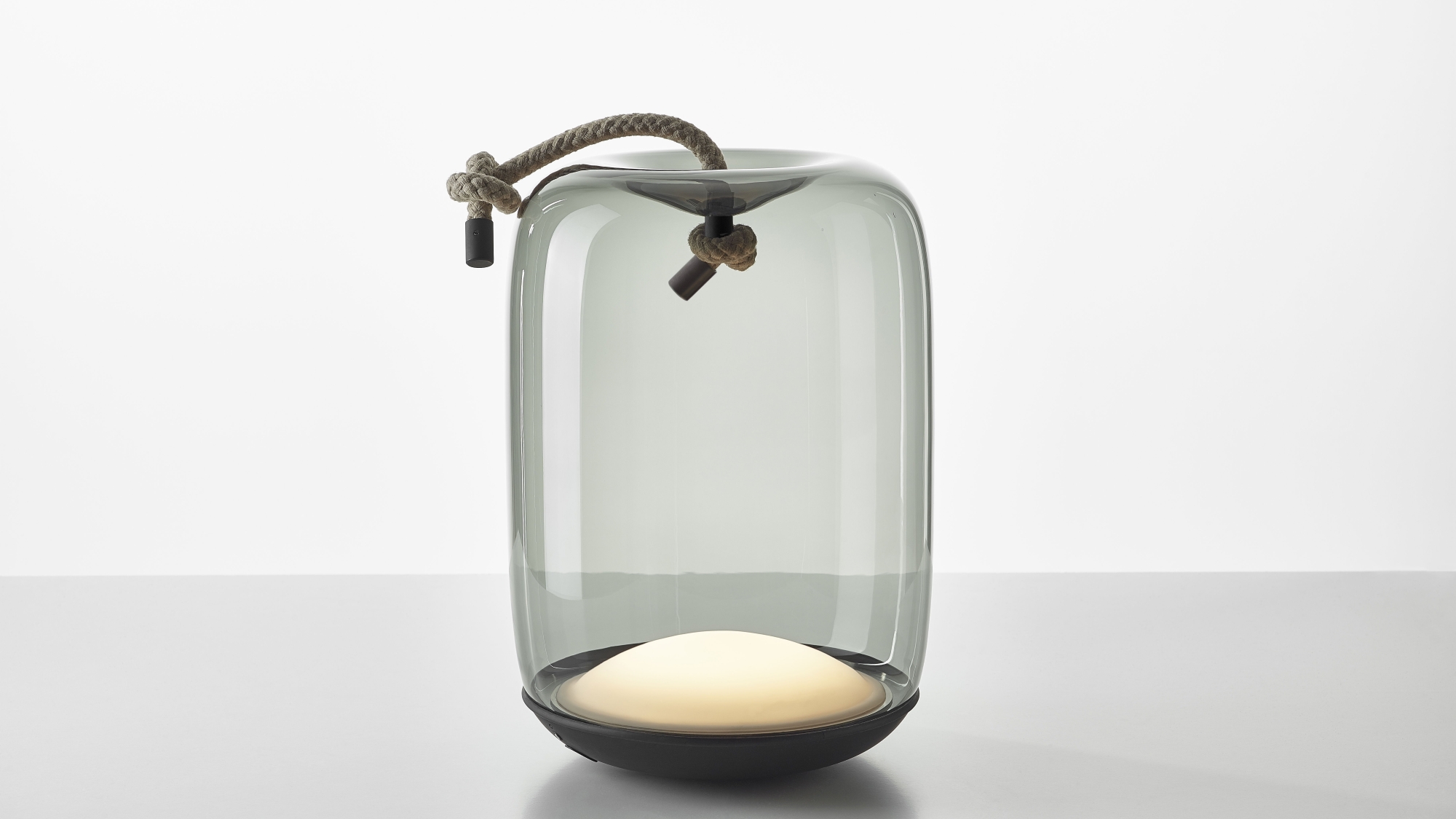 Knot Battery by Brokis grey glass, luxe rope handle, and soft glow atop a matt black base.