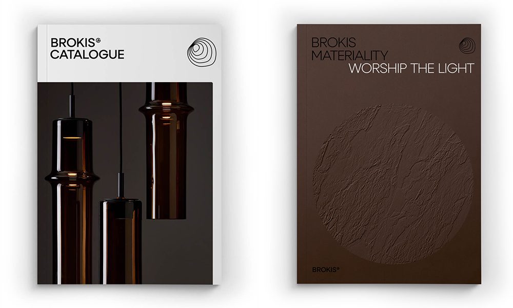 Sculptural, glossy Brokis lights grace the left booklet; right cover is brown, with 'Materiality: Worship the Light.'