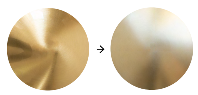 Two brass discs - one glossy with elegant swirl patterns, one matt - are set side by side.