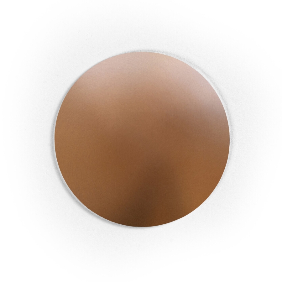 A smooth, circular copper disc with a metallic sheen rests on white.