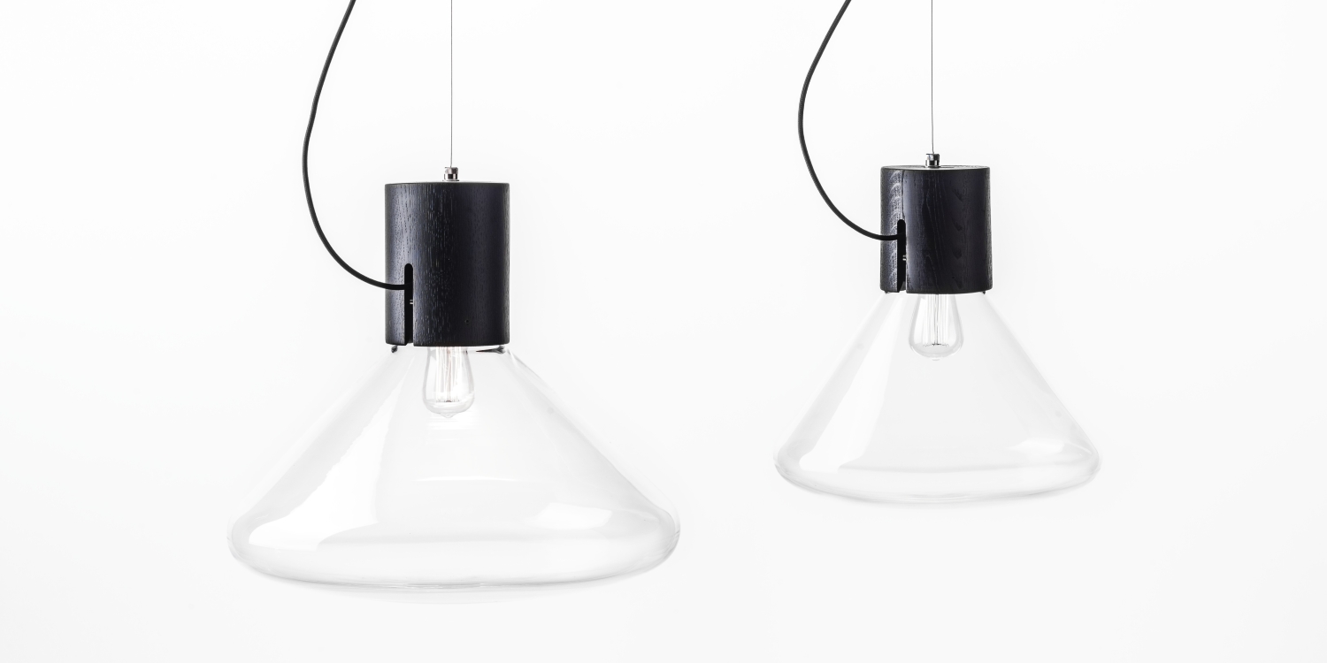 Brokis Muffins Wood 05 pendants: handblown glass cones, black oak body, exposed bulbs - sculptural luxury on black flexes.