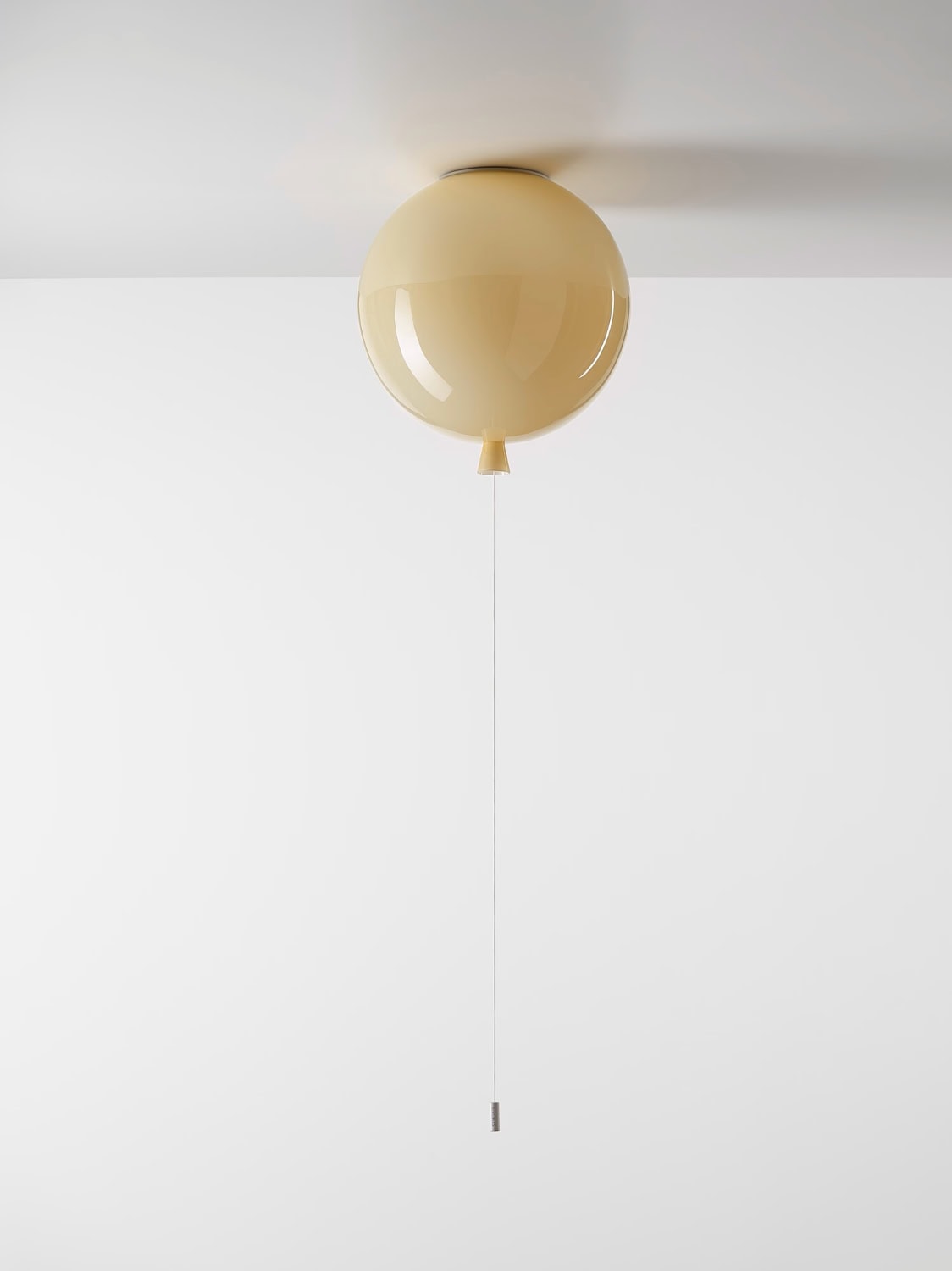 Brokis Memory Ceiling 250 light floats on a white ceiling, its delicate pull evoking a luxury balloon.