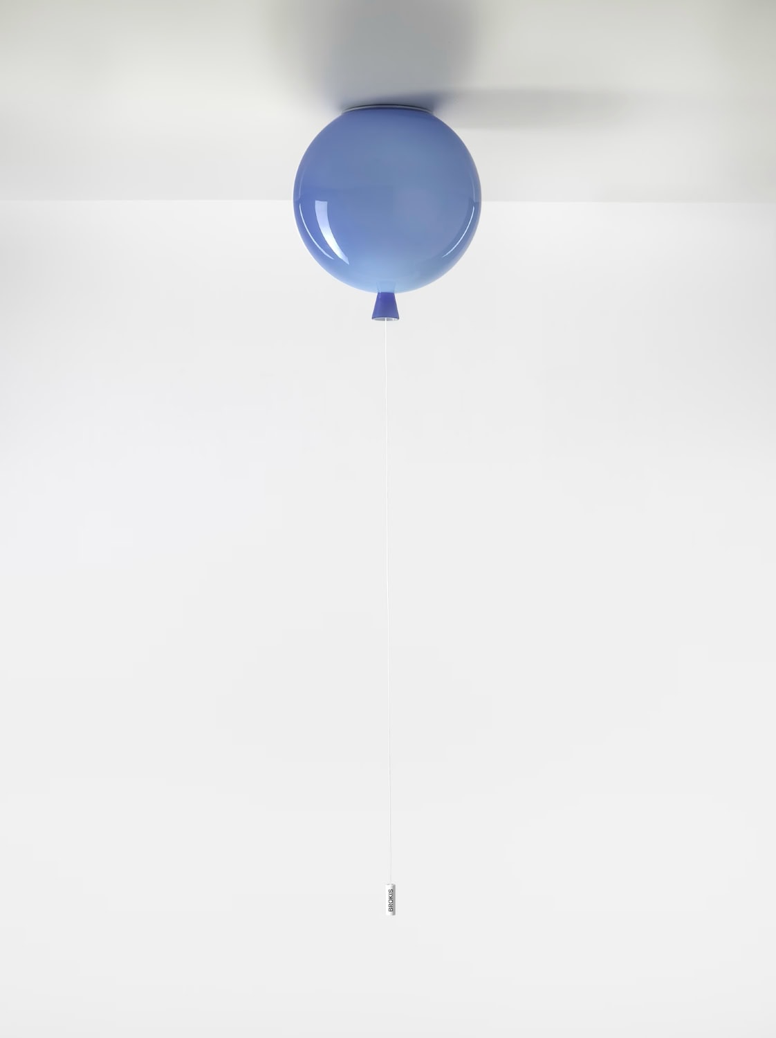 Brokis Memory Ceiling 250 in handblown blue glass graces a white room; a slender cord descends elegantly.