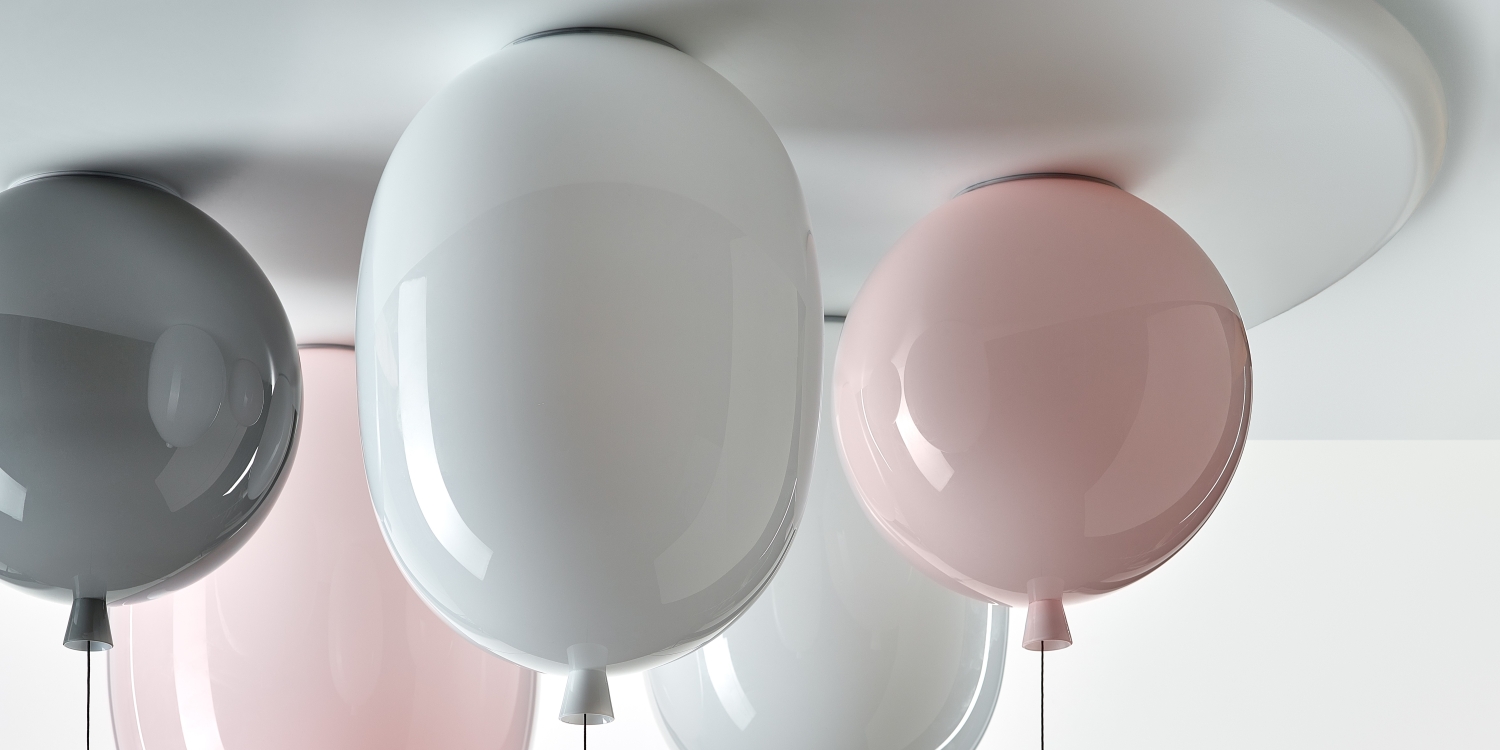 Brokis Memory Set L Oval lights in grey, white, and pink create a sculptural statement on the white ceiling.
