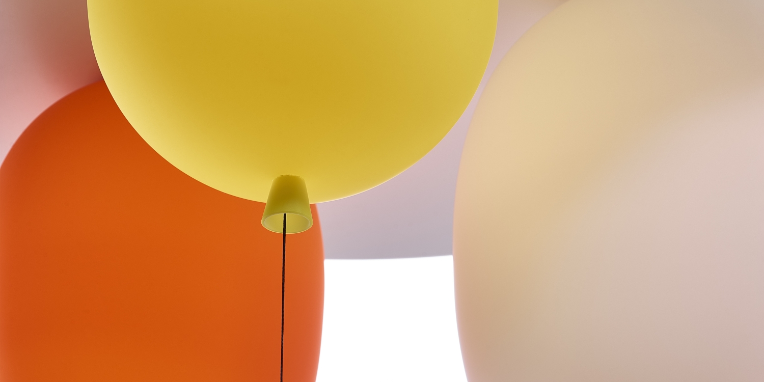 Close-up of Brokis Memory Set S Oval in yellow, orange, pink, and white; matt finish glows against a soft backdrop.