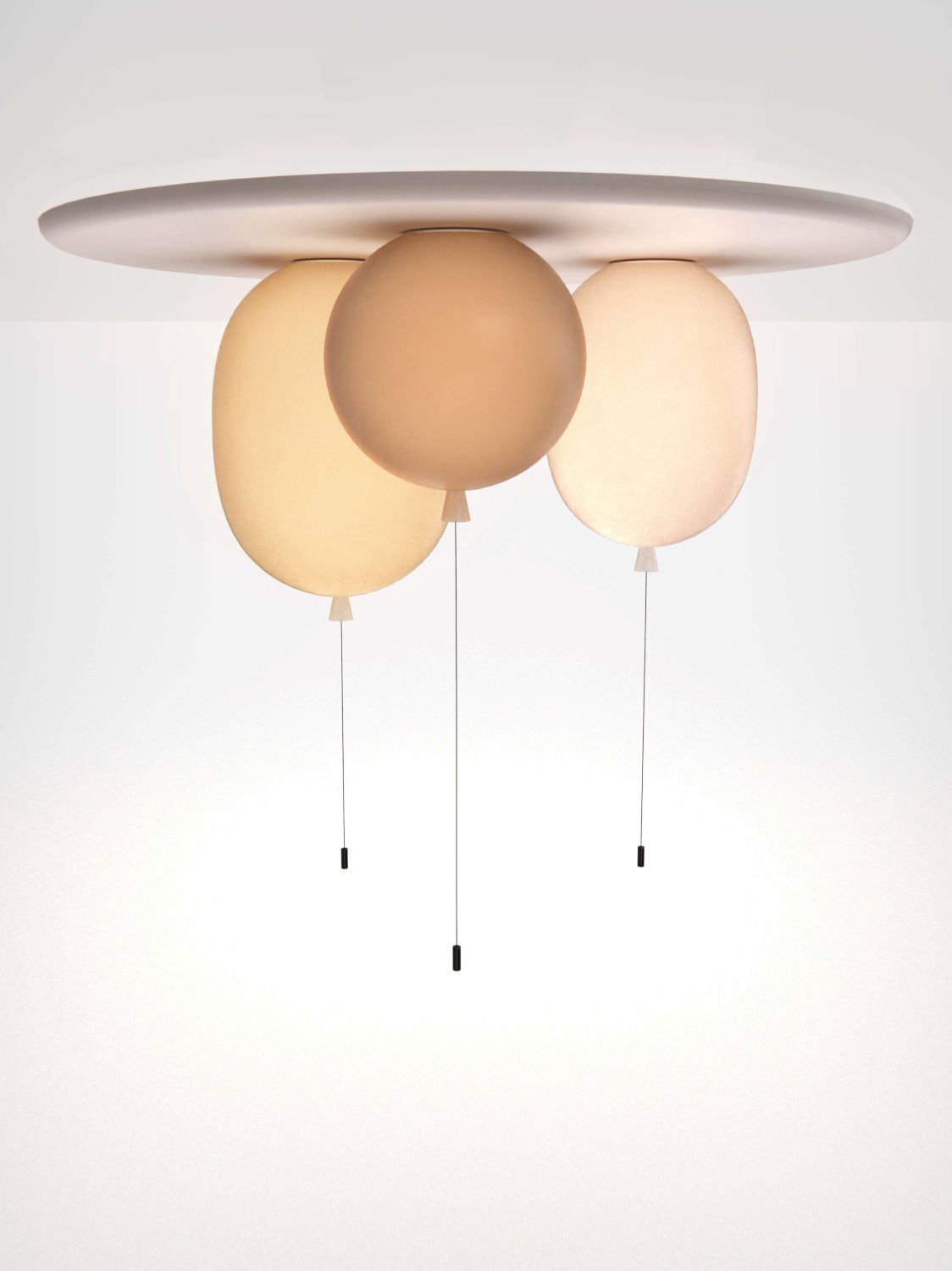 Brokis Memory Set S Oval: three sculptural, handblown glass lights in warm hues, suspended from a sleek white plate.