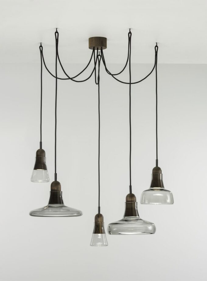 Brokis Shadows Set Free pendant lights feature sculptural, handblown glass shades on black flexes, exuding refined elegance.