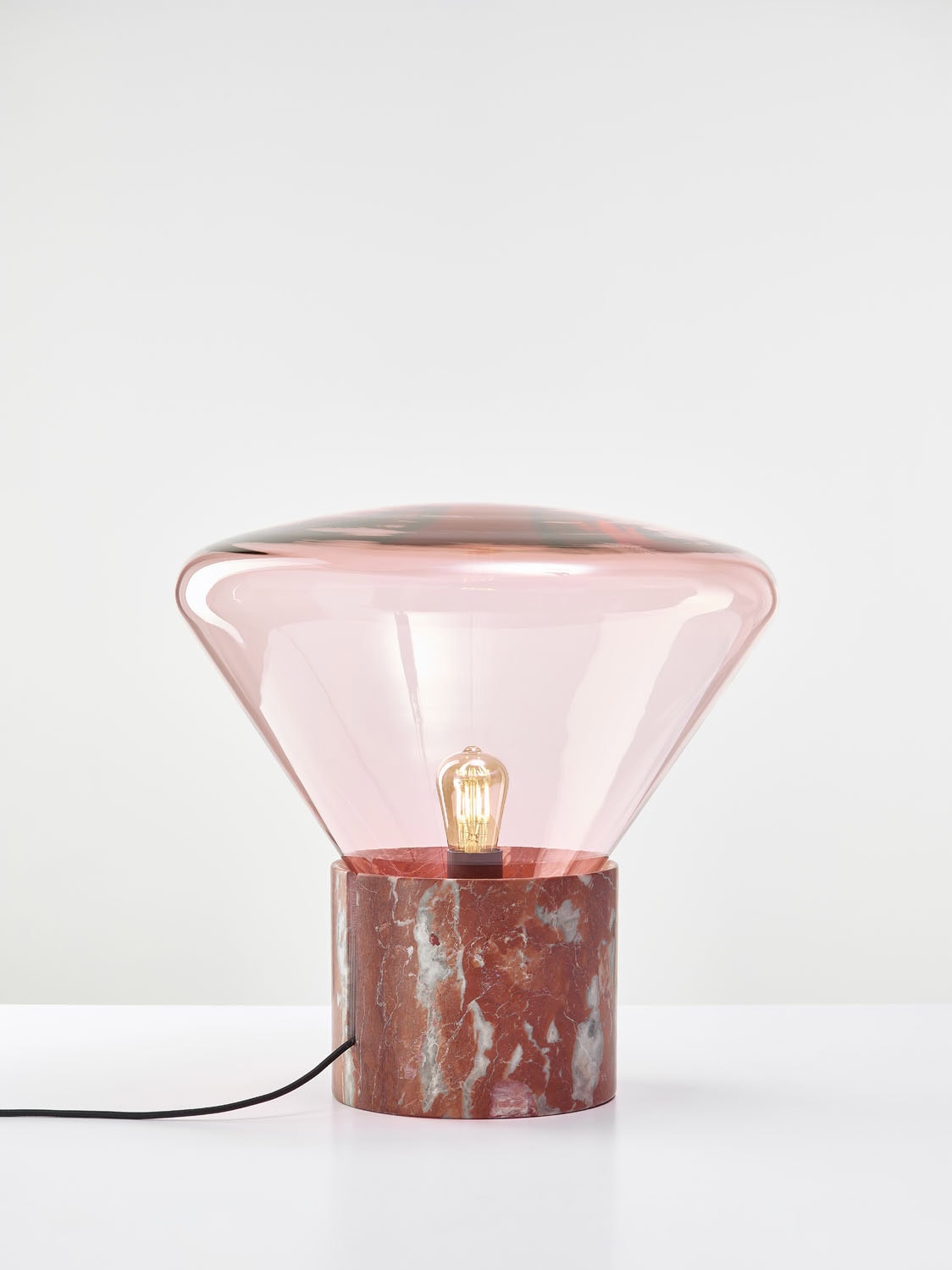 Brokis Muffins Wood 02 Table lamp pairs red marble and handblown pink glass for a refined, modern statement.