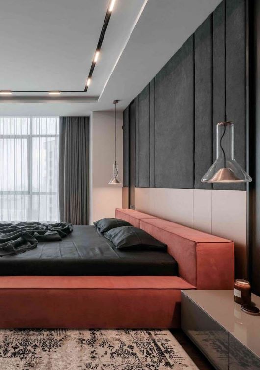 Luxurious bedroom with upholstered bed, Brokis Whistle Medium pendants, and sheer-curtained window for natural light.