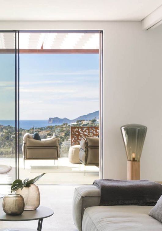 Sleek living room with neutral hues, Muffins Wood 04 Floor, overlooking ocean views and an expansive blue sky.