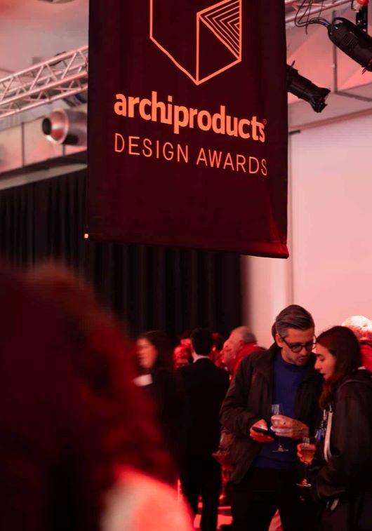 Guests mingle at a chic indoor Archiproducts Design Awards event.