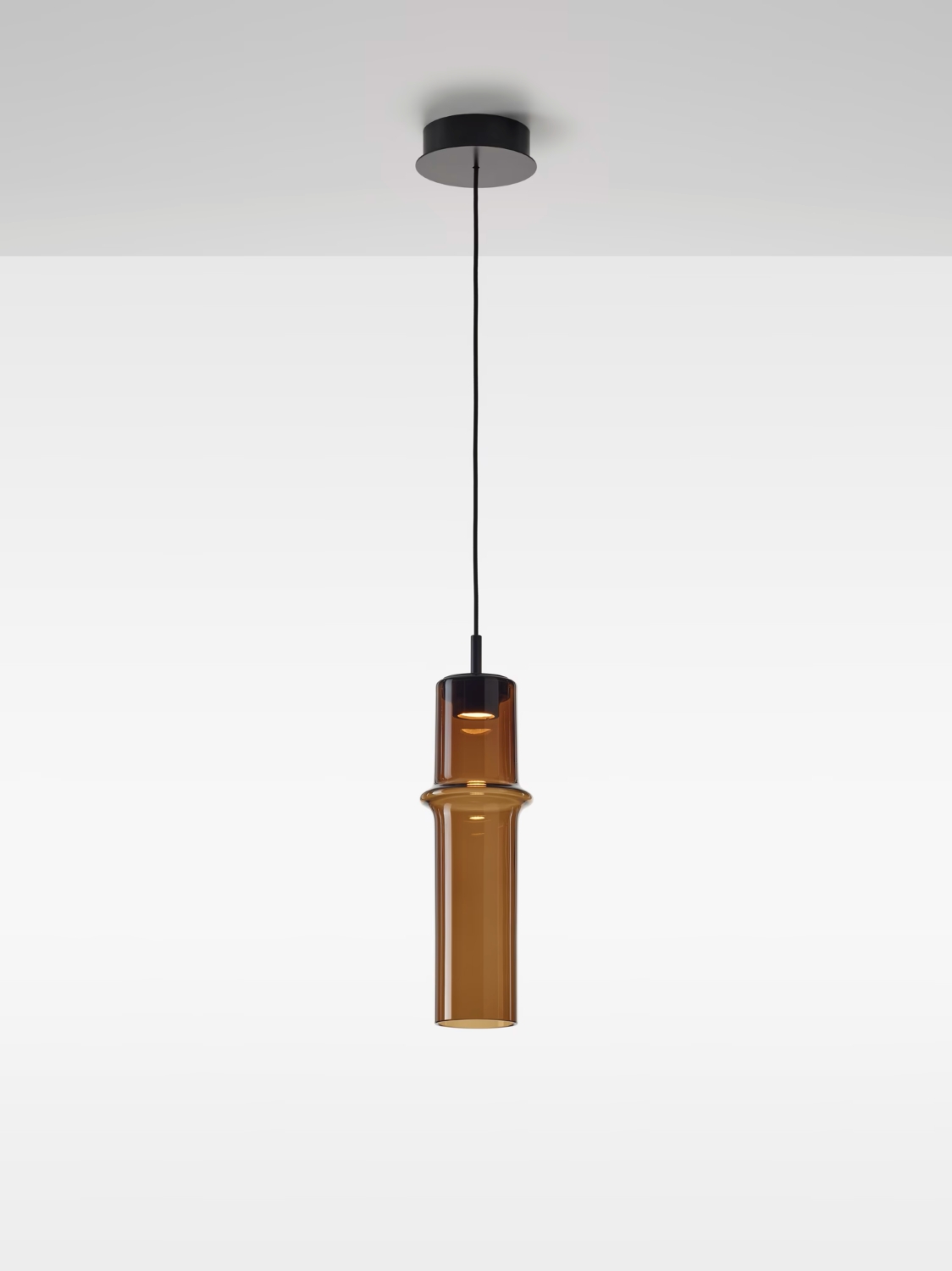 Brokis Bamboo Forest M Up Pendant: a hand-blown brown glass shade with ringed detail, exuding luxury from a white ceiling.