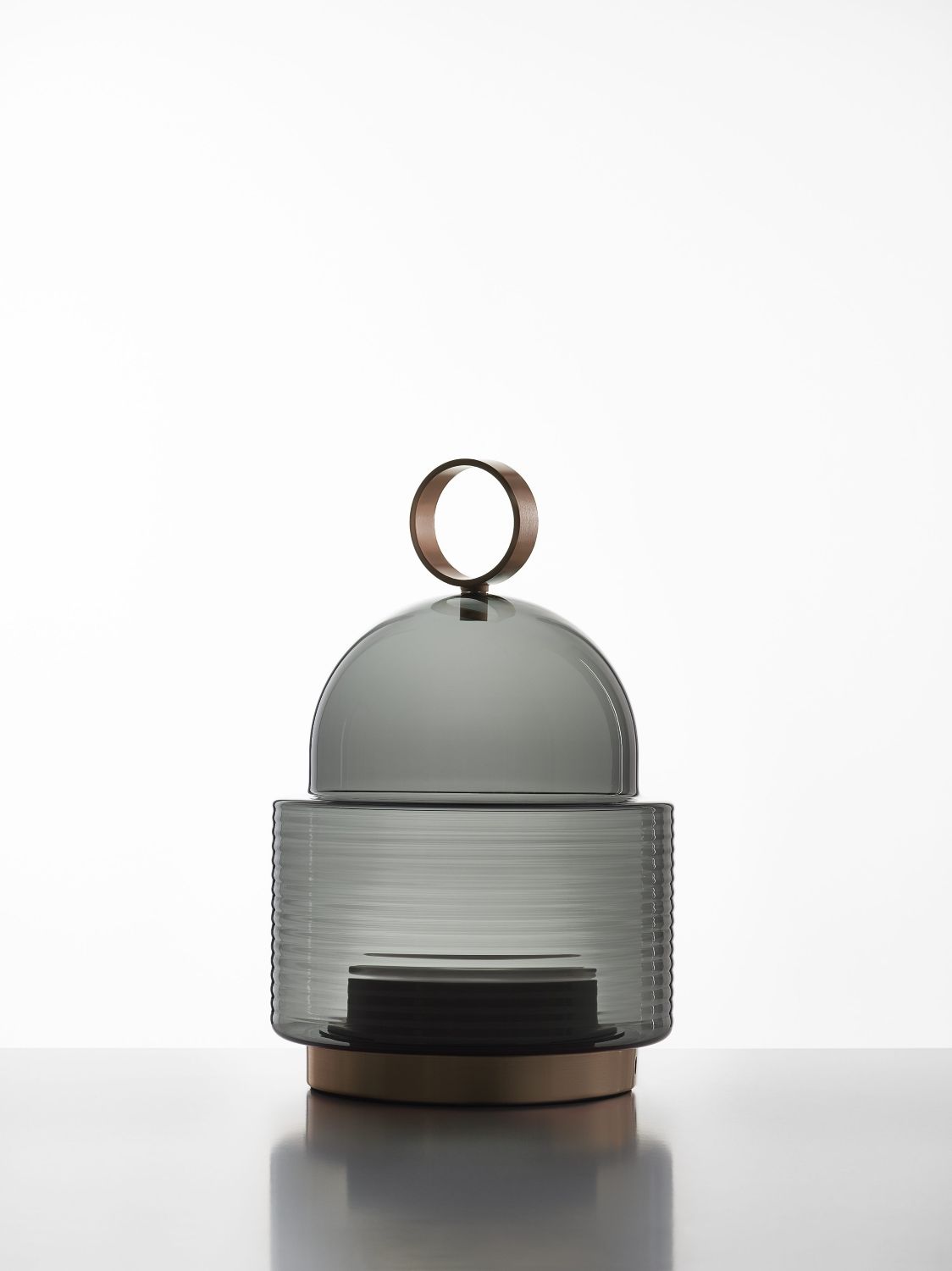 Brokis Dome Nomad Small features sculptural ribbed glass, a refined metallic base, and domed glass top.