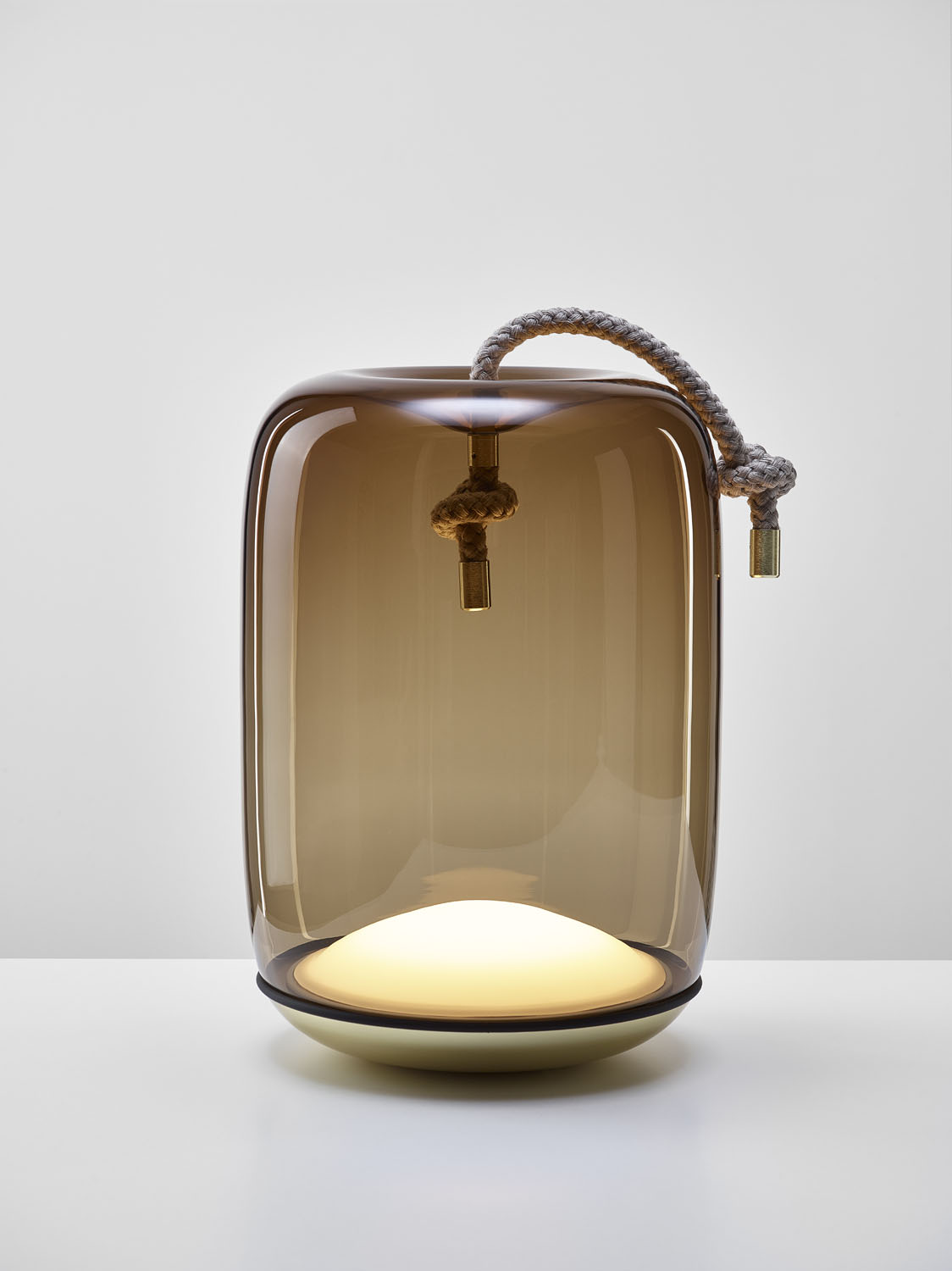 Brokis Knot Cilindro Table Battery pairs handblown brown glass with a sculptural warm glow and luxe rope handle.