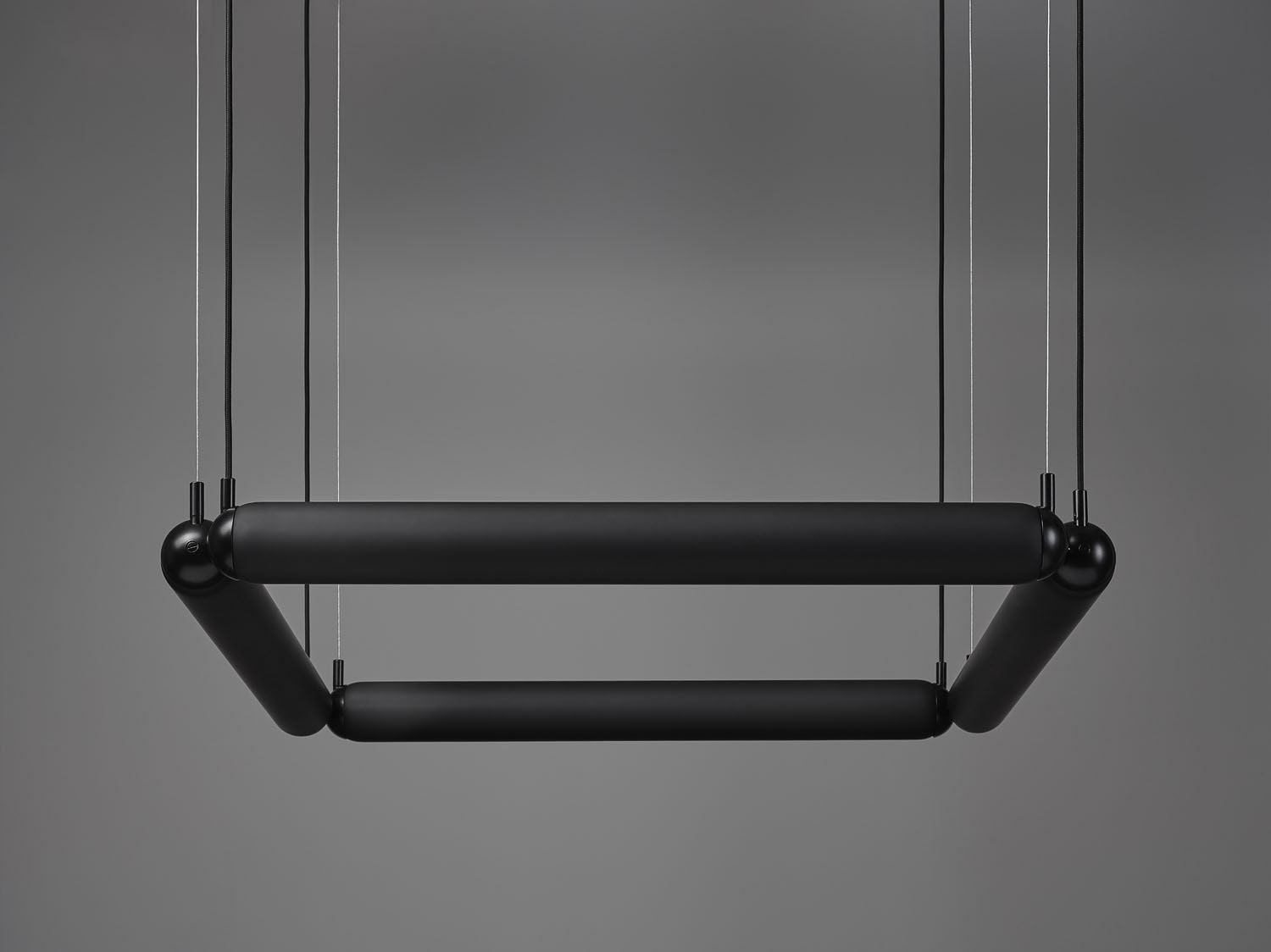 Brokis Puro Contour Square 800: a sculptural, handblown matte black chandelier with rounded corners, floating in space.