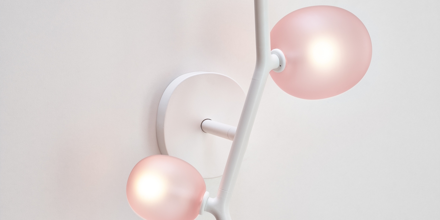 Brokis Ivy Wall: a sculptural, handblown lamp with light pink glass shades, softly illuminating elegant interiors.