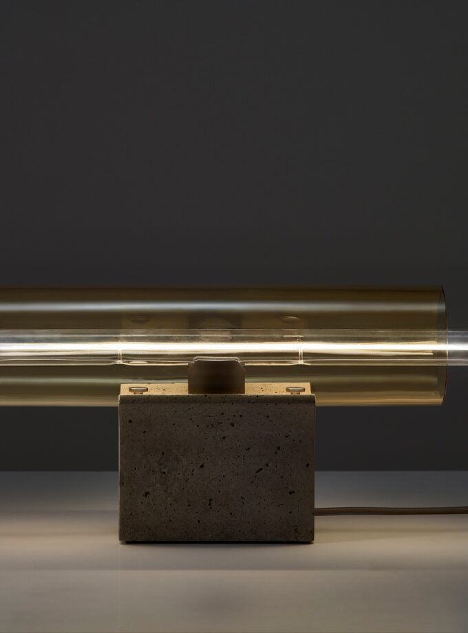 Brokis Overlay Table M boasts a sculpted concrete base, handblown amber glass shade radiating soft luxe light.