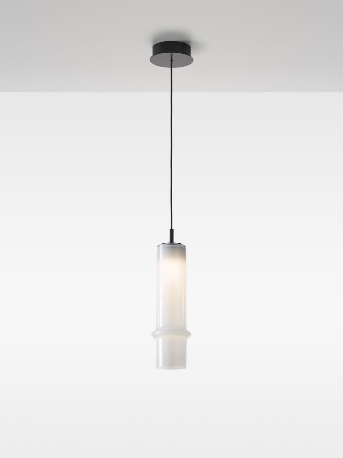 Brokis Bamboo Forest M Pendant: hand-blown opaline glass cylinder on sleek black cord, casting a softly diffused glow.