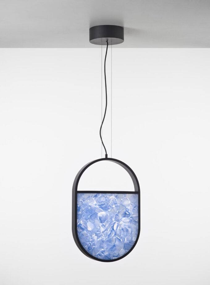 Brokis Geometric Oval Pendant: handblown blue BROKISGLASS cradled by a sculptural black frame, elegantly diffusing light.