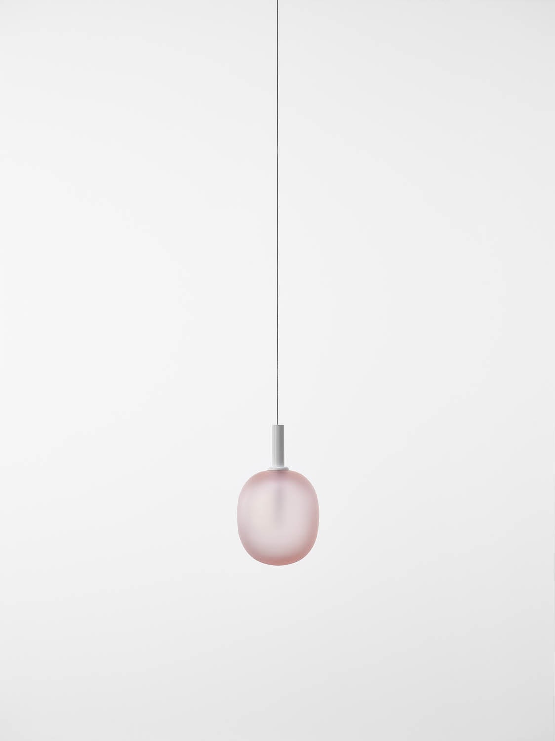 Brokis Ivy Single L Pendant showcases a handblown light pink glass shade, suspended elegantly from a slender silver cord.