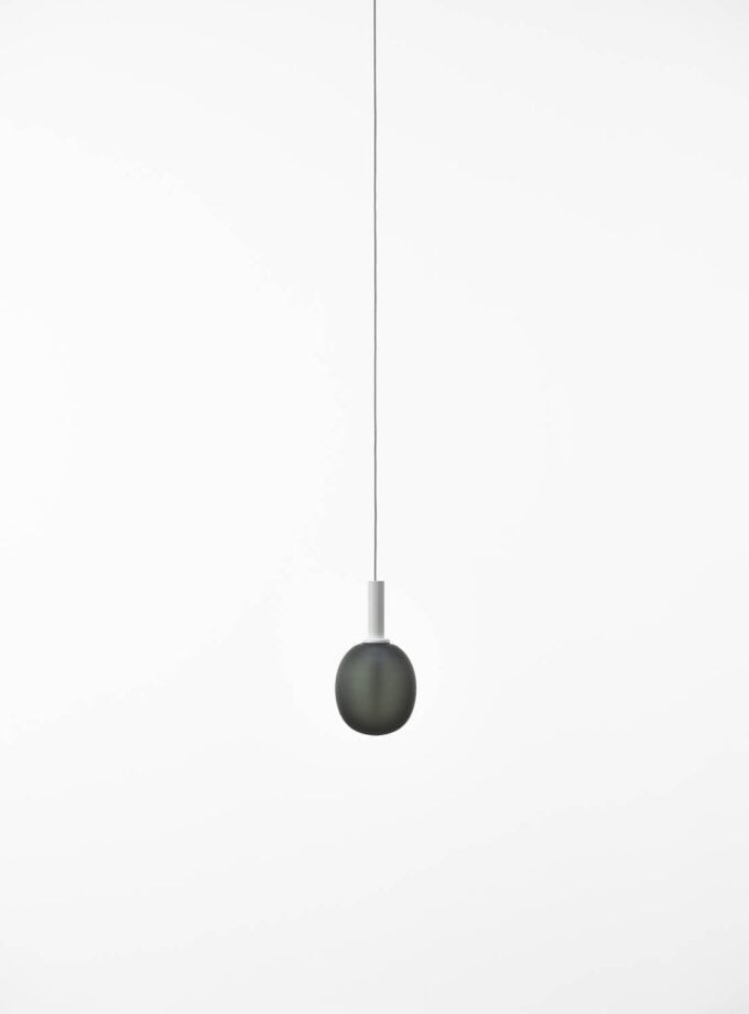Brokis Ivy Single S Pendant in handblown smoke grey glass, hangs elegantly from a thin white lead against white.