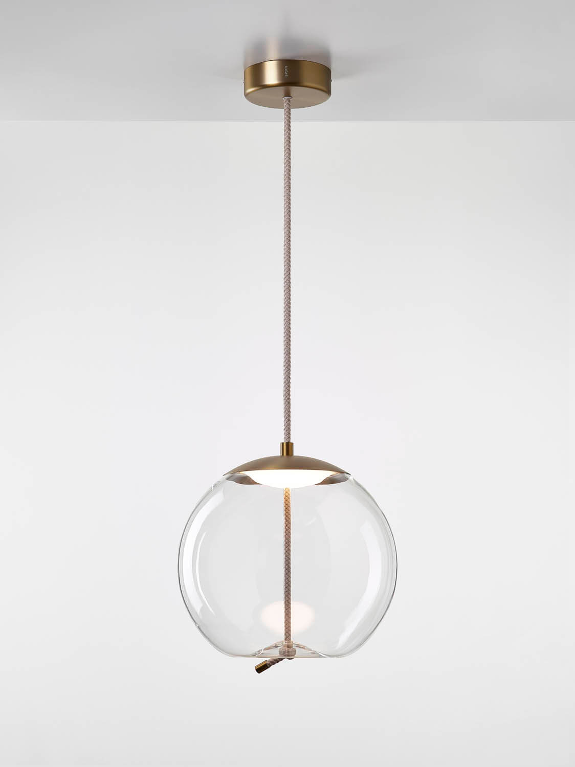 Brokis Knot Sfera Pendant in handblown transparent glass, brass detailing, and textured cord exudes modern luxury.