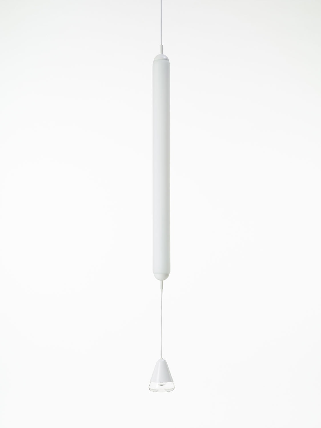 Brokis Puro Single Vertical 1000 Pendant, a handblown white tube, suspends elegantly against a pure white background.