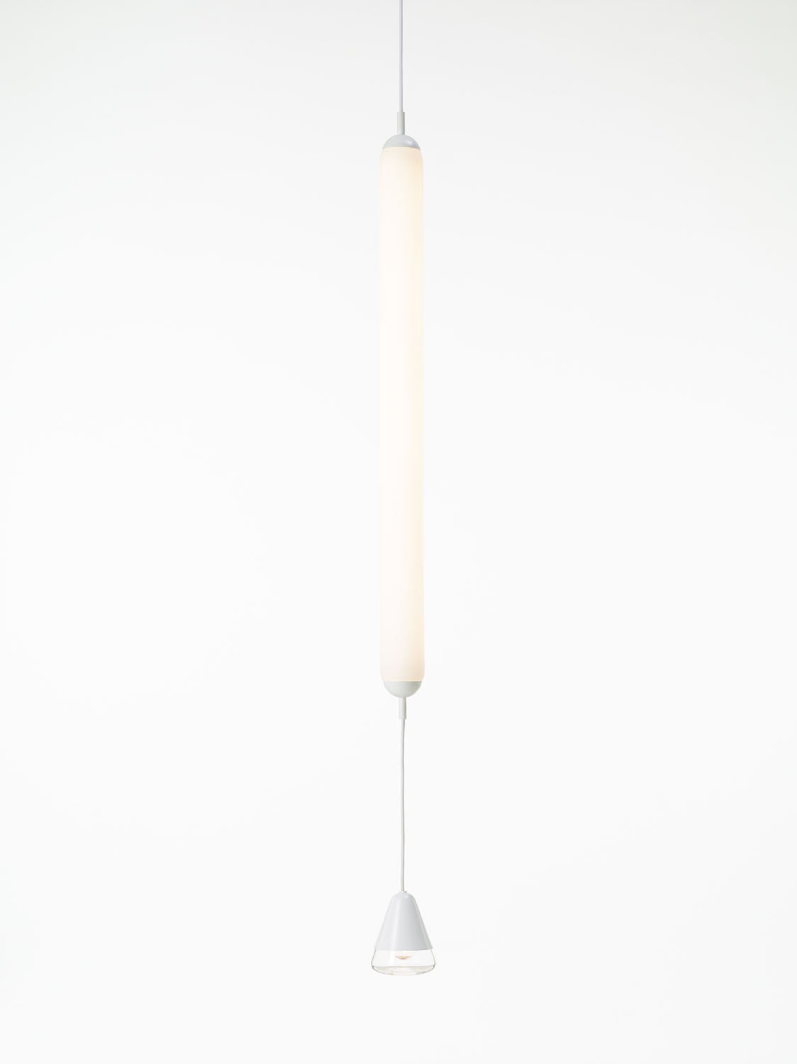 Brokis Puro Single Vertical 1000 Pendant features a handblown cylindrical form and soft white glow, exuding modern luxury.