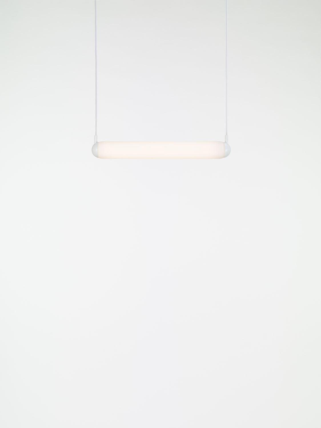 Brokis Puro Solo Horizontal 600 Pendant glows softly, suspended on slim cords for a refined sculptural statement.