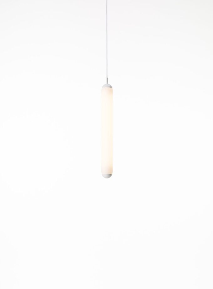 Brokis Puro Solo Vertical 600 Pendant, handblown frosted glass, casts a soft glow in minimalist luxury against white.