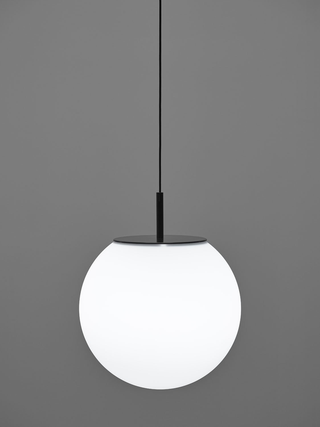 Brokis Sfera 300 Pendant showcases a handblown, sculptural white glass orb with matt black accents in a luxe setting.