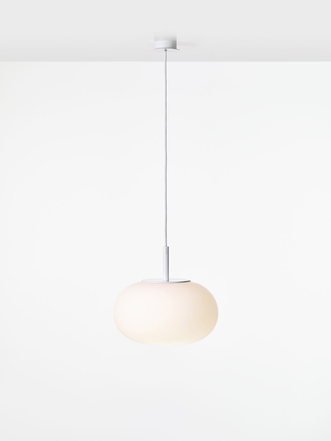 Brokis Sfera Oval 380 Pendant boasts a handblown frosted glass shade, exuding sleek luxury against a white backdrop.