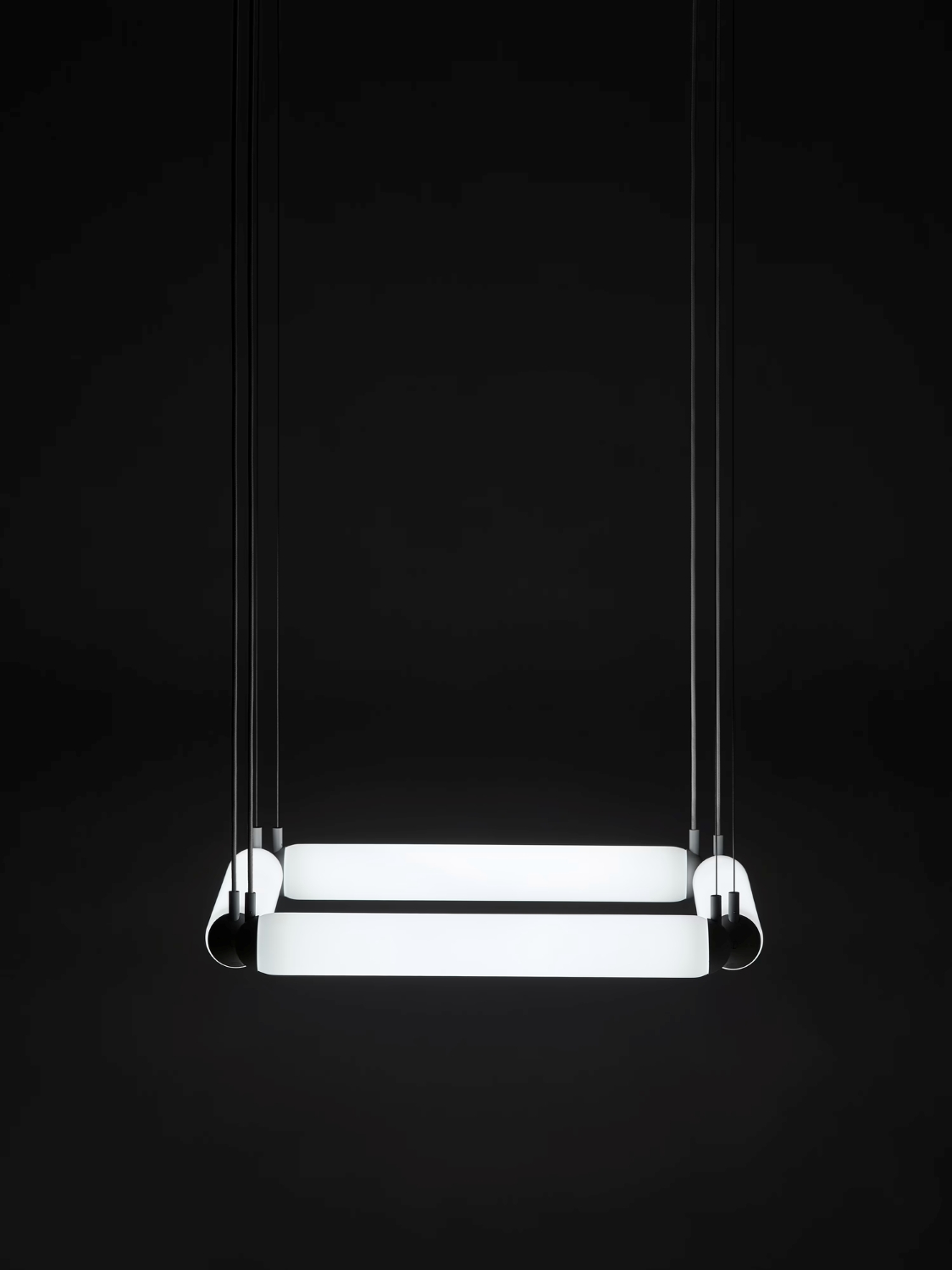 Brokis Puro Contour Square 600 Chandelier features handblown glass tubes, glowing softly, suspended by slender black cables.