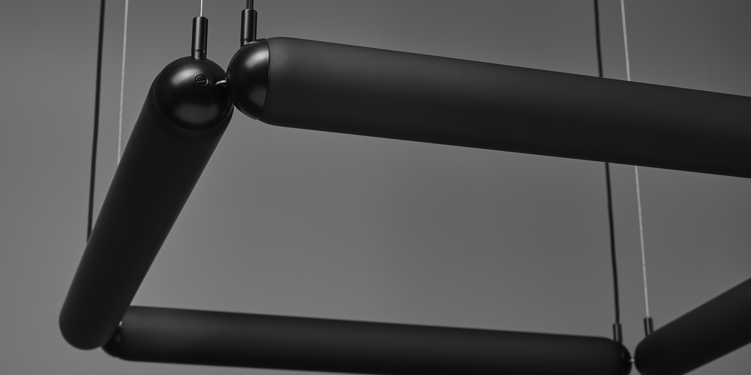 Close-up of Brokis Puro Contour Square Chandelier, a sculptural matte-black fitting with elegant rounded contours.