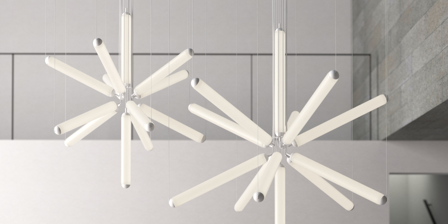 Brokis Puro Sparkle 1000 chandeliers radiate luxury, their glowing starburst arms elevate the minimalist space.