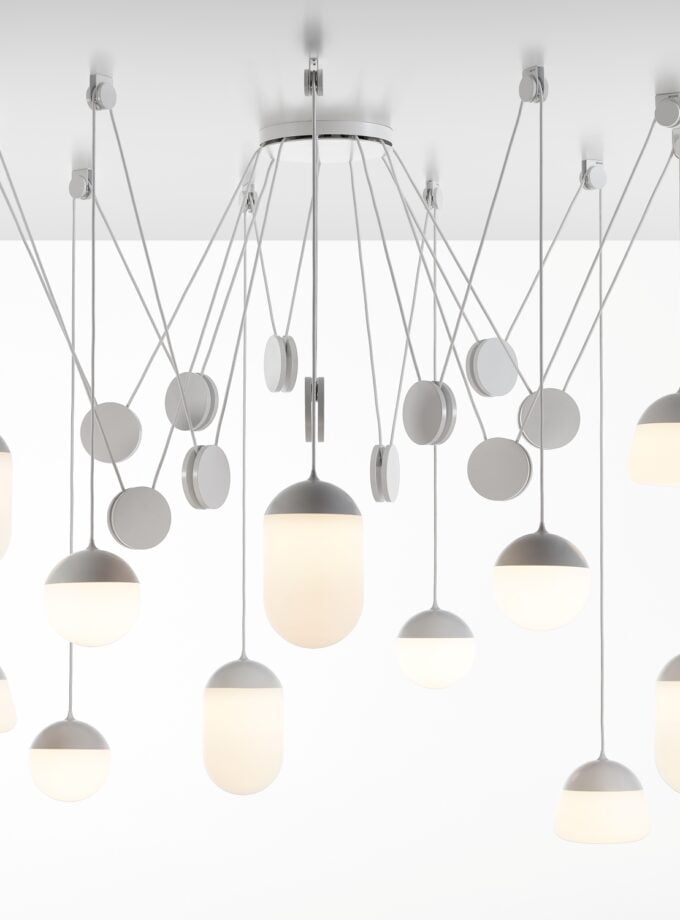 Brokis Planets 11 Set showcases sculptural, hand-blown glass lights in white, gracefully suspended at varied heights.