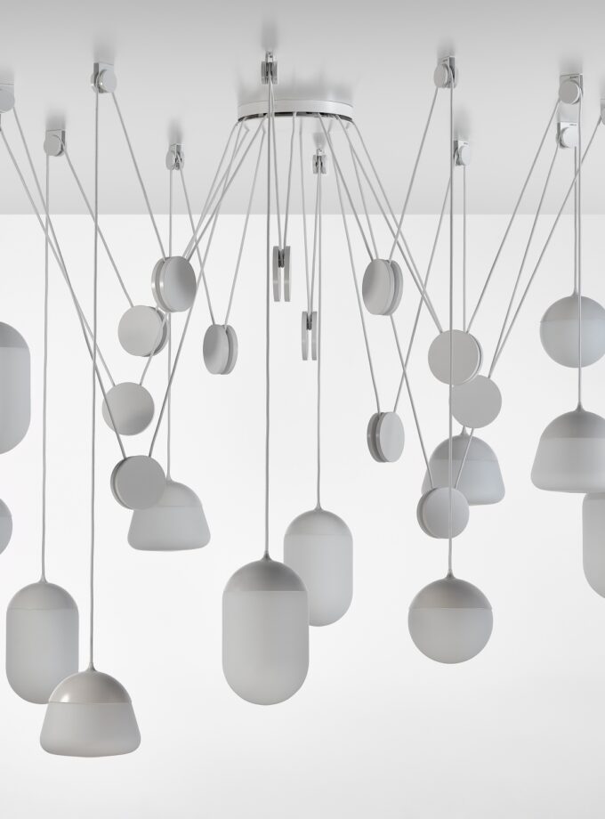 Brokis Planets 12 Set showcases sculptural lights, handblown matte white glass shades suspended elegantly at varied heights.