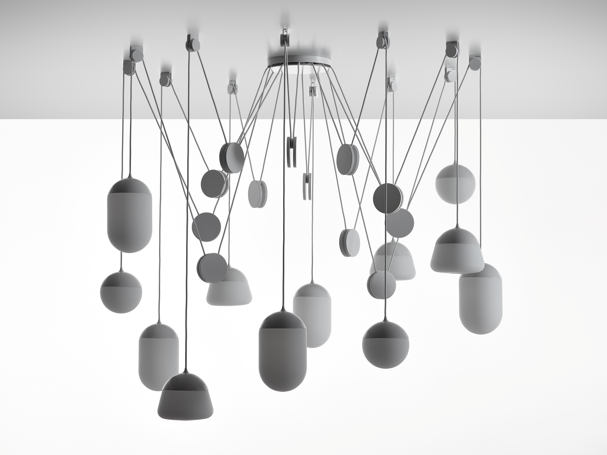 Brokis Planets 12 Set showcases handblown matt white pendants in a sculptural, minimalist cluster with elegant shadows.