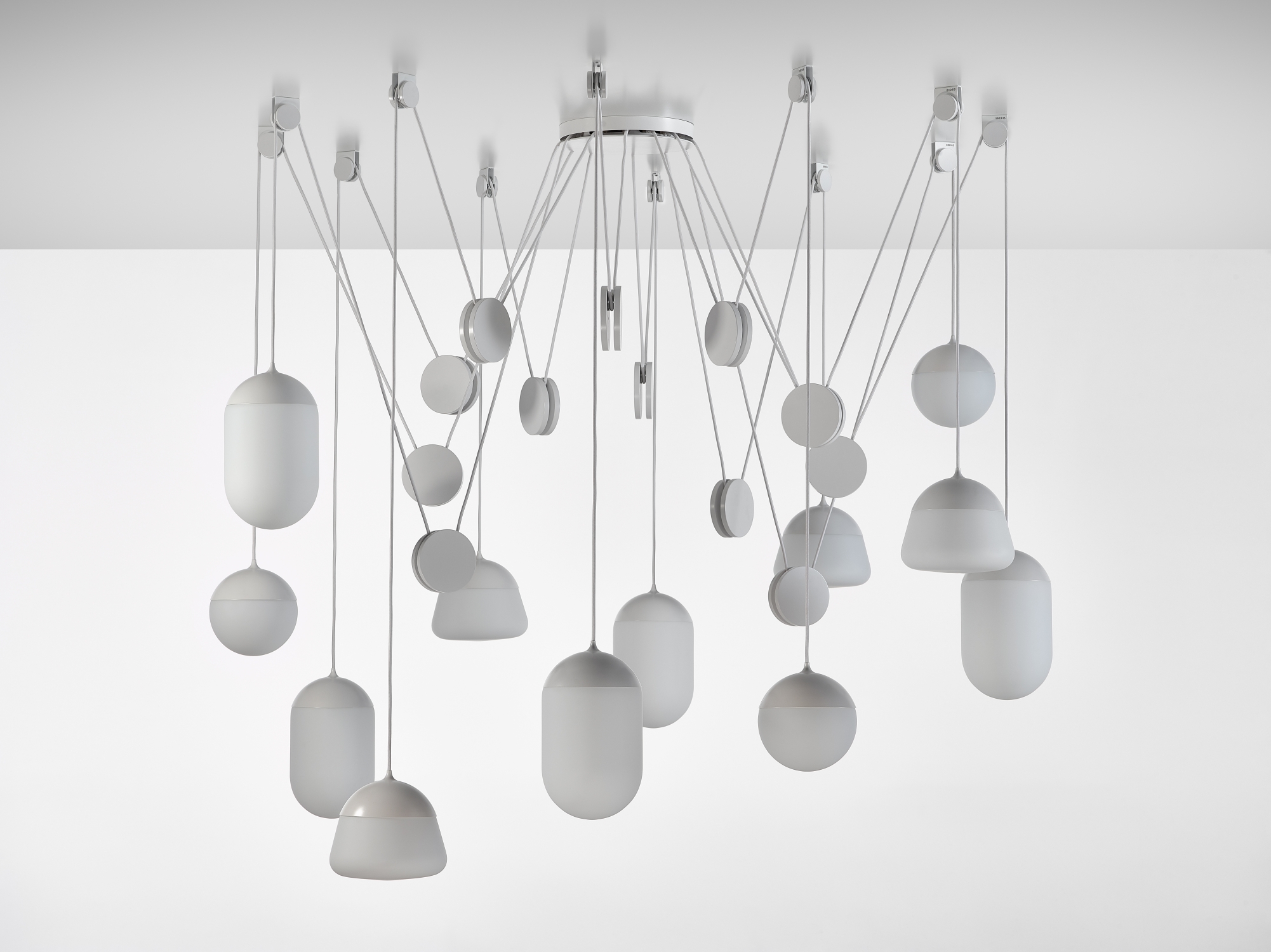 Brokis Planets 12 Set showcases sculptural lights, handblown matte white glass shades suspended elegantly at varied heights.