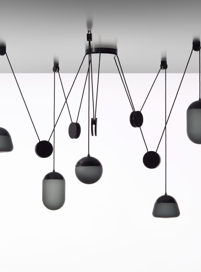 Brokis Planets 5 Set with smoke grey shades cascade at varied heights, sculpting a luxe, minimalist ceiling display.