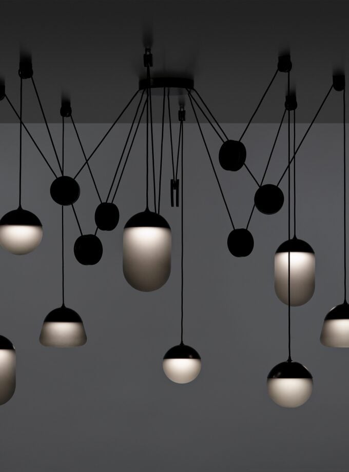 Brokis Planets 8 Set showcases eight hand-blown grey globes on black cords for a sculptural, opulent effect.