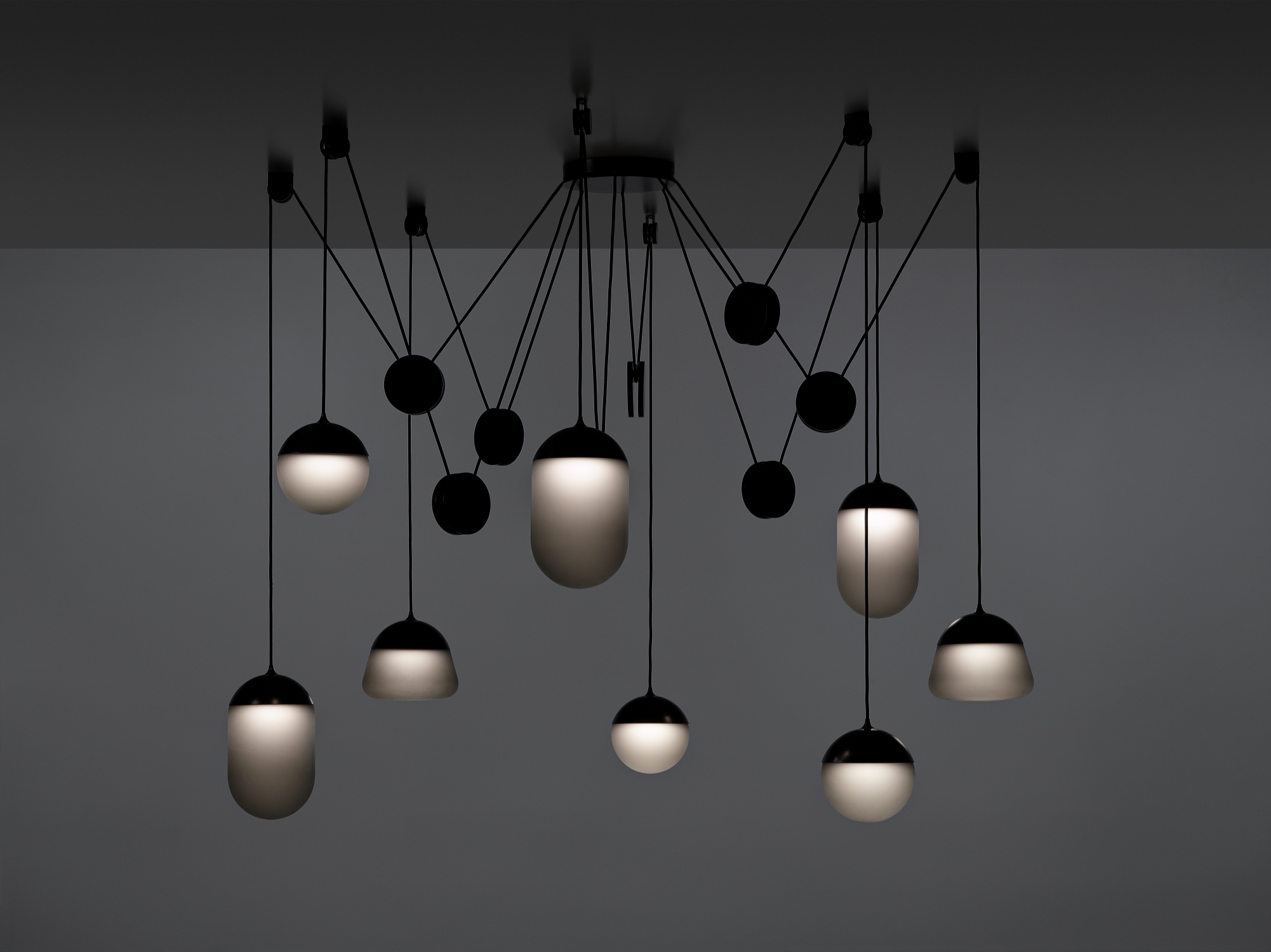 Brokis Planets 8 Set showcases eight hand-blown grey globes on black cords for a sculptural, opulent effect.