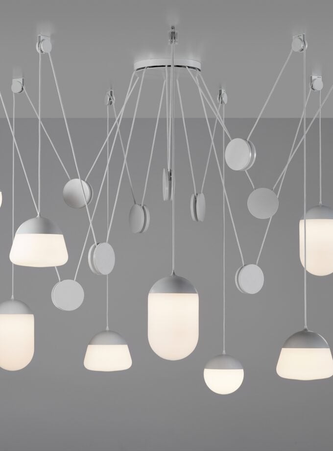 Brokis Planets 9 Set showcases nine sculptural, handblown white lights in a striking geometric arrangement.