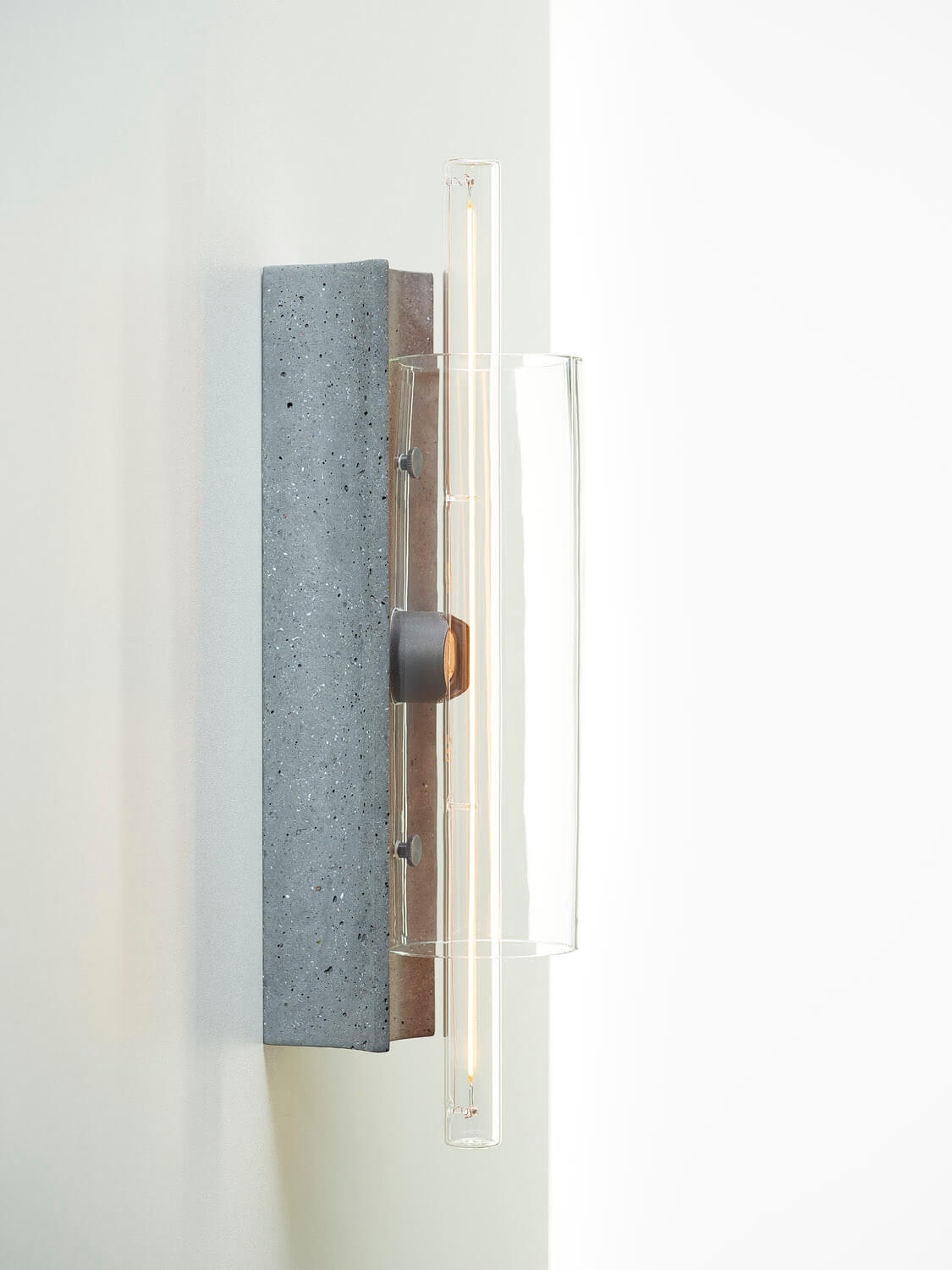 Brokis Overlay Wall M is a sculptural wall sconce with a handblown glass shade and luxe concrete accents.