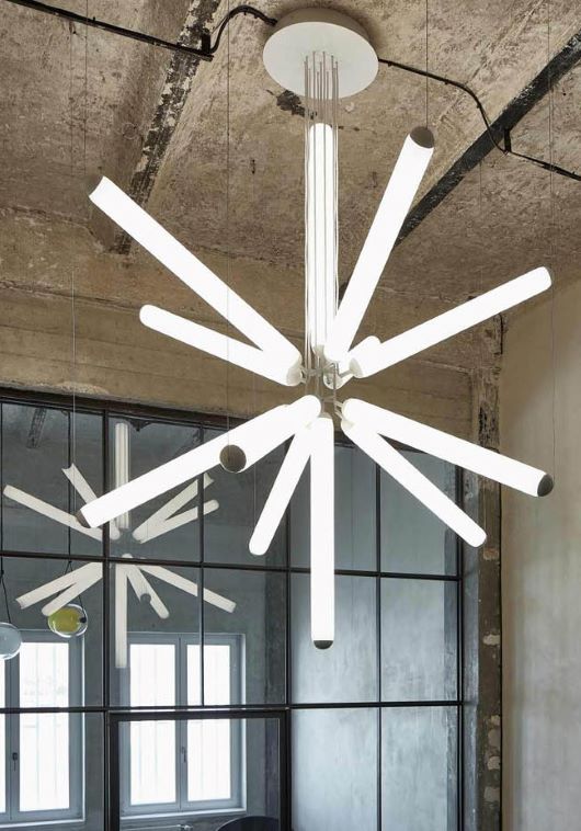 Brokis Puro Sparkle 1000 Chandelier dazzles with sculptural white LED tubes radiating in a luxurious, industrial setting.
