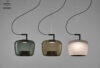 Brokis Double pendant lights in handblown green, brown, and white glass gleam in a row, exuding refined luxury.