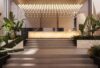 A modern hotel lobby with a backlit marble reception desk, lush greenery, and an elegant ceiling display of Ivy Single lights.