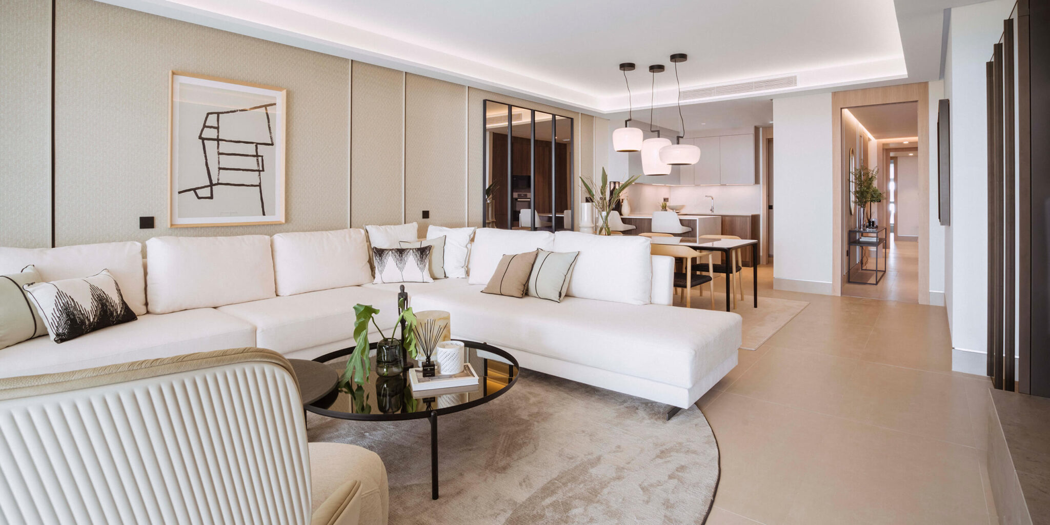 A luxurious, modern living room with a white sofa, a chic coffee table and Brokis Double pendants.