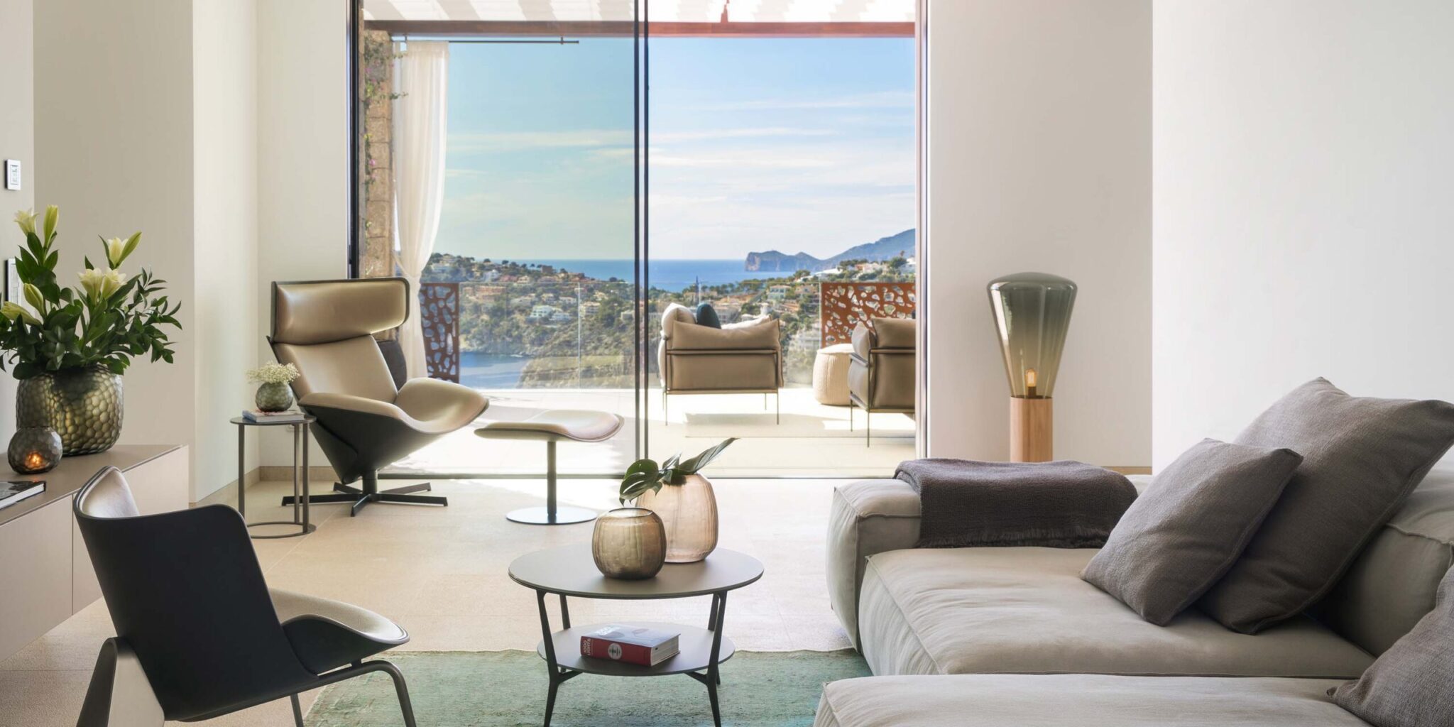 Sophisticated lounge with neutral furnishings, Muffins Wood 04 Floor, lush plants, and sea-view terrace.