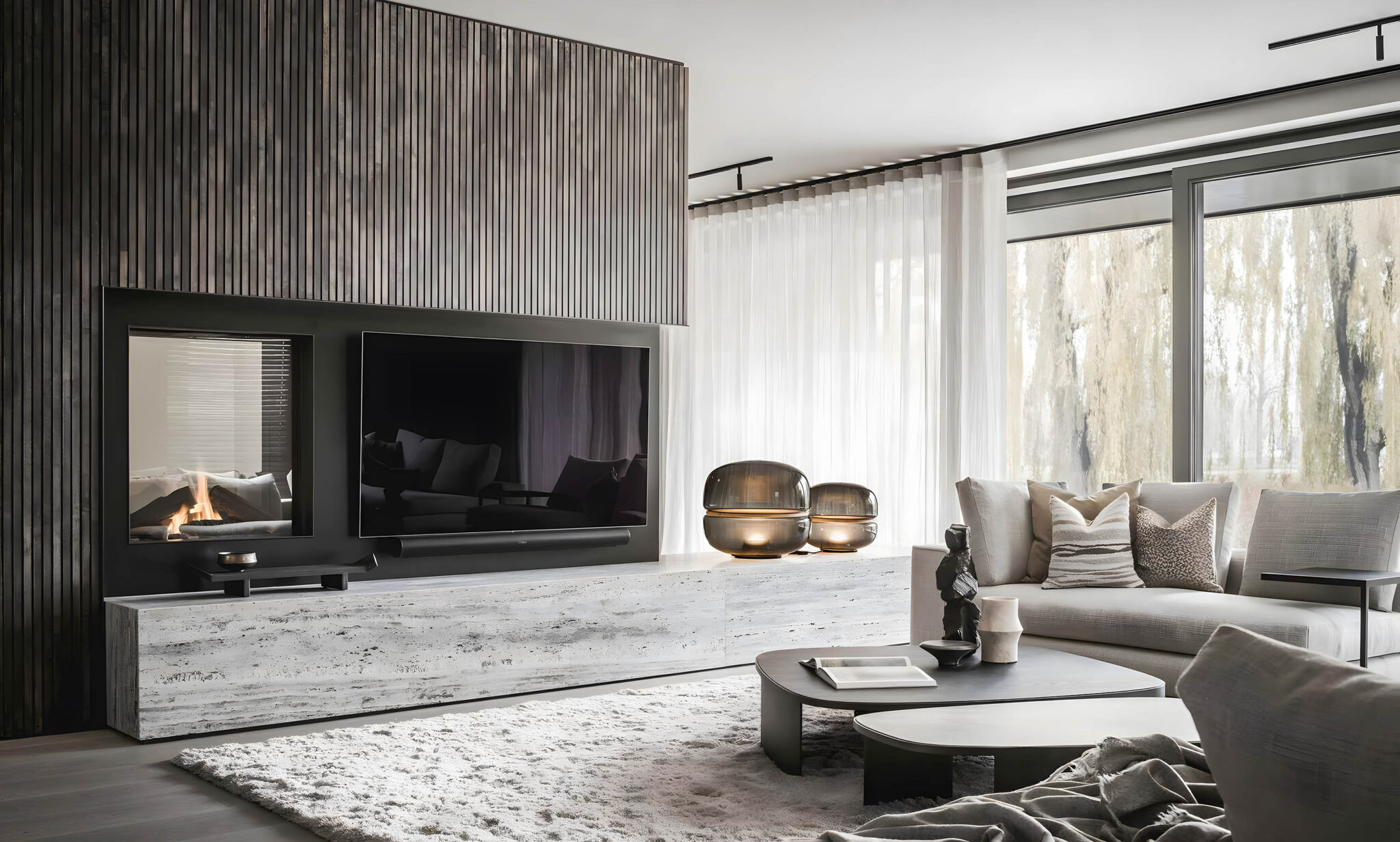 Light-filled living room with Brokis Macaron glass lamps, sleek fireplace, and plush neutral furnishings.